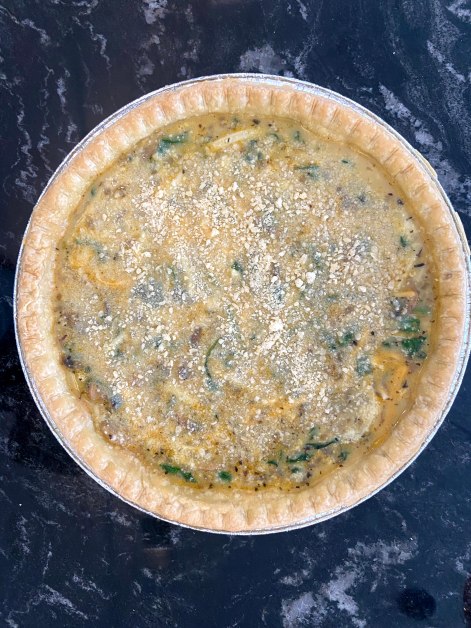 Pour mixed ingridients over pie crust, sprinkle parmesan cheese 